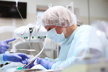 Portrait of a pediatric dentist during surgery under General anesthesia. Removal of deep caries. Copy of the space.