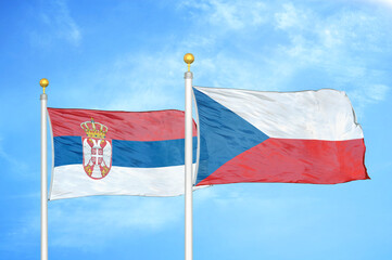 Serbia and Czech Republic two flags on flagpoles and blue sky