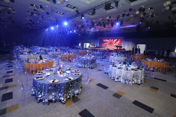 Event setup for a function with table Decore and blue lighting.