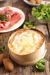 mont d'or- traditional french melted cheese with salami and potato