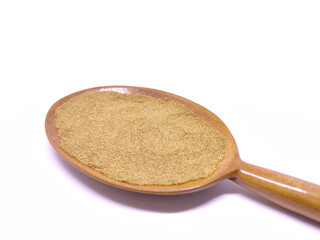 Ground cumin in a wooden spoon isolated on white background. Garam masala.