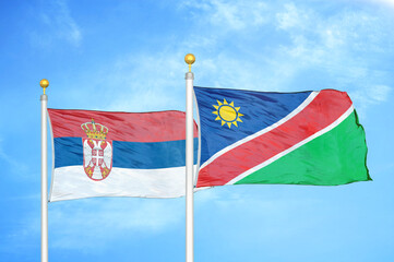 Serbia and Namibia two flags on flagpoles and blue sky