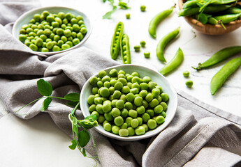 Green peas in white bowls