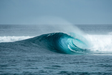 Perfect blue aquamarine wave, empty line up, perfect for surfing, clean water, Indian Ocean. © Lila Koan