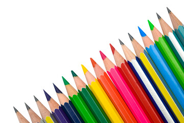 A line of different color wood pencil crayons placed on a white background