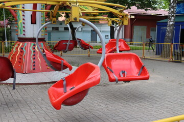 red plastic seat of speedy carousel