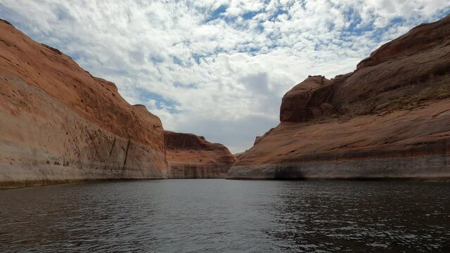 Boat ride through rock cliff Lake Powell Utah POV. Beautiful man made reservoir on Colorado River between Utah and Arizona. Vacation spot for boating and all outdoors recreation.
