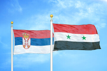 Serbia and Syria two flags on flagpoles and blue sky