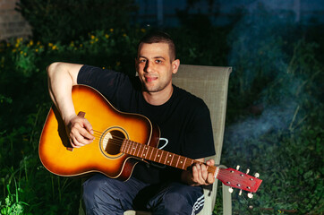 Obraz premium man plays the guitar.