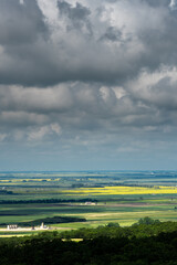 Fototapeta na wymiar Aerial views Prairie landscapes of yellow and green fields under bold cloudy skies bright lighted areas