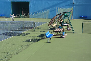 tennis court arena with hard surface and tribunes