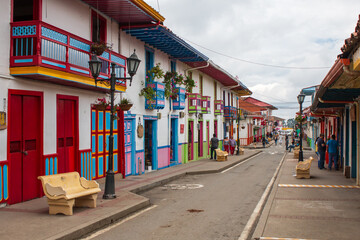 main commercial street with spanish colored balconies and houses at salento, colombia