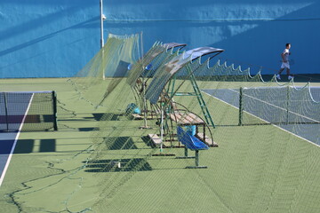 tennis court arena with hard surface and tribunes