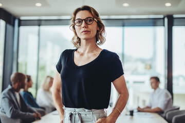 Portrait of a confident business woman standing in boardroom