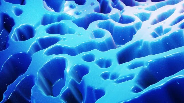 fantastical festive blue bg. Stylish abstract looped background, waves move on glossy surface like landscape made of liquid blue wax with sparkles. Beautiful soft background with smooth animation 4k