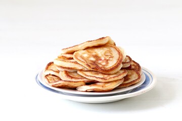 Pancakes in a plate on a white background