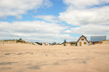 Vallizas is a beach town in Uruguay on the shores of the sea. A beach white old houses in the sand on the ocean. Fisherman and artisans village. Tranquility and peaceful destination.