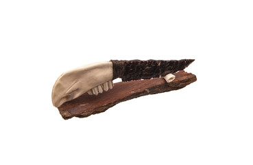 Obsidian knife with bone handle isolate on a white back. Prehistoric weapon made of volcanic glass.