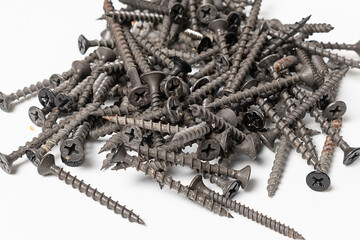 Black wood screws with philips head on white background