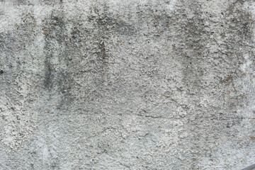 old gray stone wall with dark spots