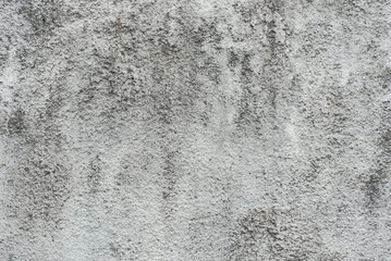 old gray stone wall with dark spots