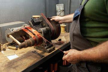 production of copper wire, a man works in a workshop at an electric engine plant