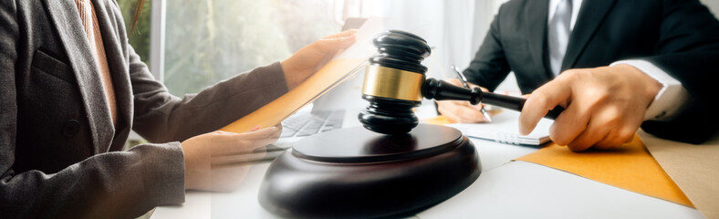 Business and lawyers discussing contract papers with brass scale on desk in office. Law, legal services, advice, justice and law concept picture with film grain effect