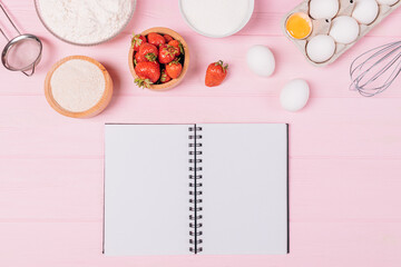Blank notebook next to ingredients and utensils
