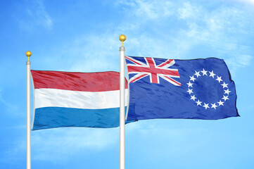 Netherlands and Cook Islands two flags on flagpoles and blue sky