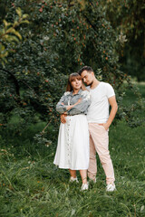 gentle and stylish couple walking in a summer park