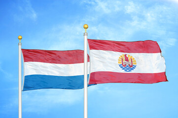 Naklejka na ściany i meble Netherlands and French Polynesia two flags on flagpoles and blue sky