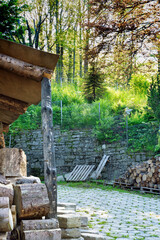 Obraz premium Bielsko Biala, South Poland: Sunrise sunset rays penetrating through tall trees and woods cut below shed on a hilltop