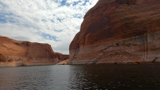 Boating Lake Powell Utah water recreation tall cliff POV Part 2. Beautiful man made reservoir on Colorado River between Utah and Arizona. Vacation spot for boating and all outdoors recreation.