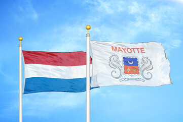 Netherlands and Mayotte two flags on flagpoles and blue sky