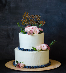 two tiered wedding Cream cheese cake with roses and blueberries