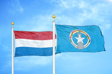 Netherlands and Northern Mariana Islands two flags on flagpoles and blue sky