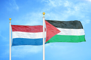 Netherlands and Palestine two flags on flagpoles and blue sky