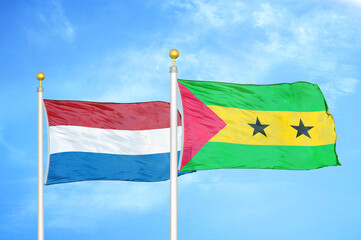 Netherlands and Sao Tome and Principe two flags on flagpoles and blue sky