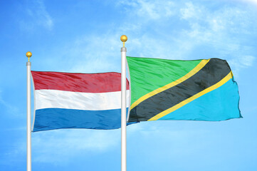 Netherlands and Tanzania two flags on flagpoles and blue sky