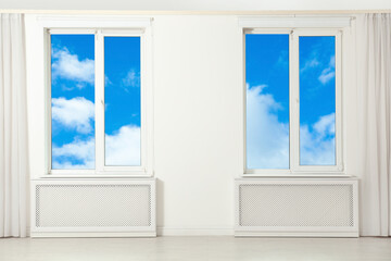 Beautiful view on blue sky with clouds through windows in room