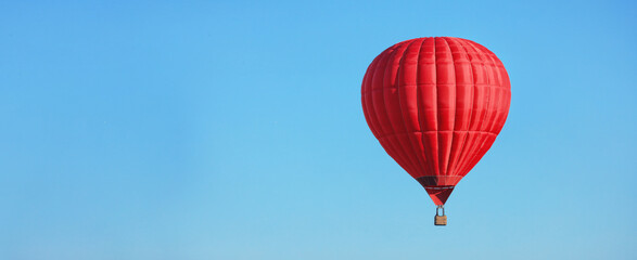 Hot air balloon in blue sky, space for text. Banner design