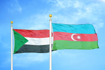 Sudan and Azerbaijan two flags on flagpoles and blue sky