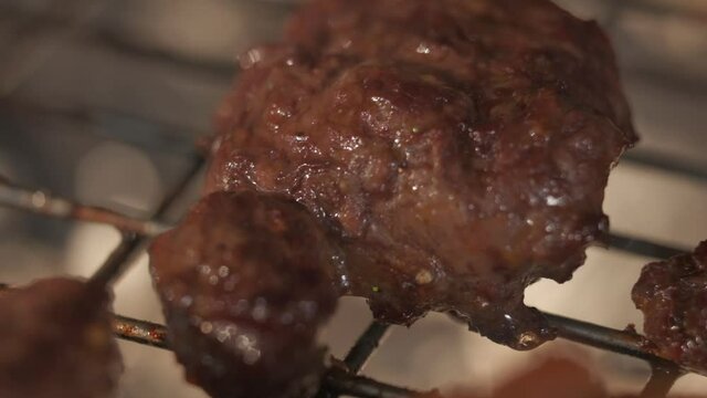 Meat grilling. Putting pices on grill grate. Slow motion