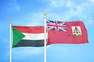 Sudan and Bermuda two flags on flagpoles and blue sky
