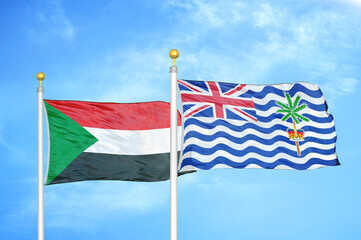 Sudan and British Indian Territory two flags on flagpoles and blue sky