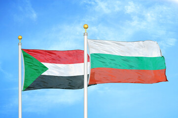 Sudan and Bulgaria two flags on flagpoles and blue sky