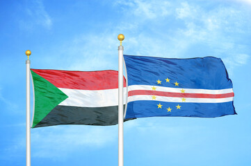 Sudan and Cape Cabo Verde two flags on flagpoles and blue sky