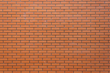 Brick wall background. The texture of a decorative brick is brown. Close-up