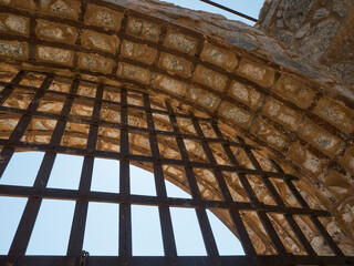 Upward view of prison bars and arch at an historic jail