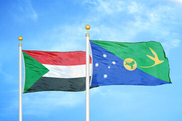 Sudan and Christmas Island two flags on flagpoles and blue sky